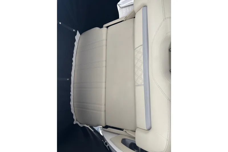 Slide: The Image of 2019 Regal 28 Express boat interior with beige leather seating. - 14