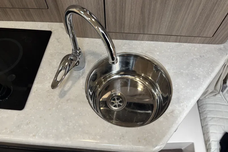 Slide: The Image of Stainless steel sink and faucet in 2019 Regal 28 Express boat kitchen. - 31