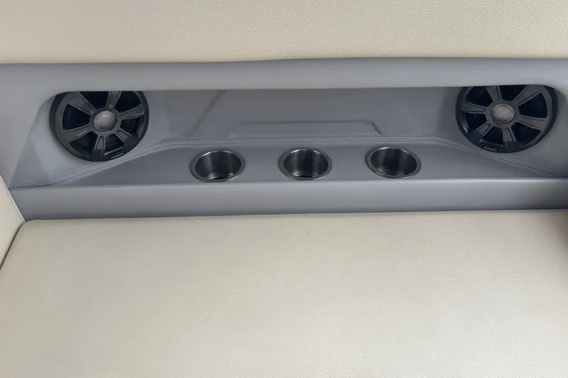 Slide: The Image of Regal 28 Express 2019 boat interior with speakers and cup holders. - 18