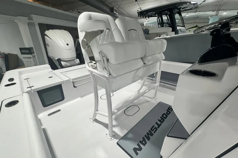 Slide: The Image of 2027 Sportsman Masters 227 Bay Boat interior with white seating and modern design. - 5