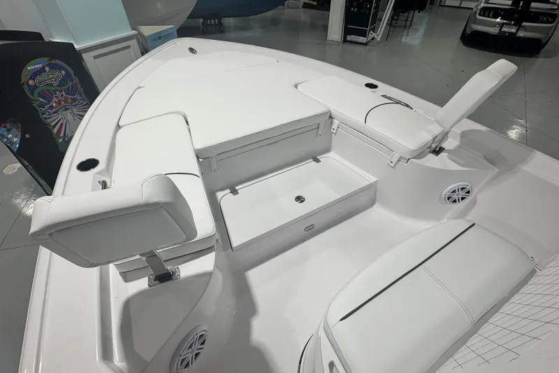 Slide: The Image of 2027 Sportsman Masters 227 Bay Boat interior with white seating and storage compartments. - 2