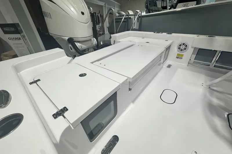 Slide: The Image of 2027 Sportsman Masters 227 Bay Boat interior with storage compartments and Yamaha engine. - 6