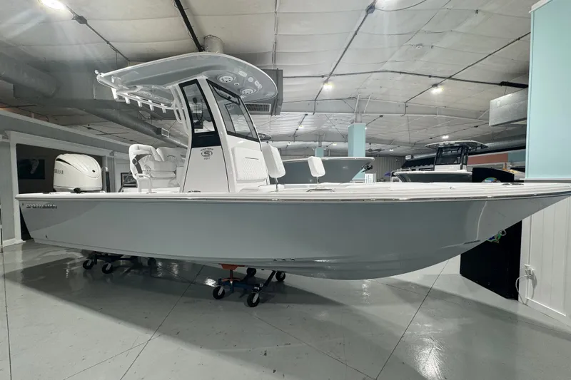 The Image of 2027 Sportsman Masters 227 Bay Boat displayed in a showroom, side view. - 0