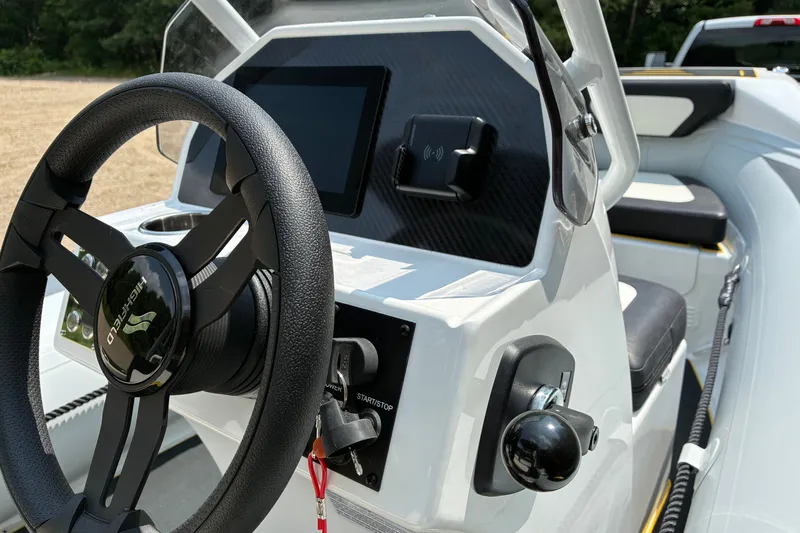 Slide: The Image of Steering console of 2026 Highfield Velox 420 boat with modern controls and sleek design. - 8