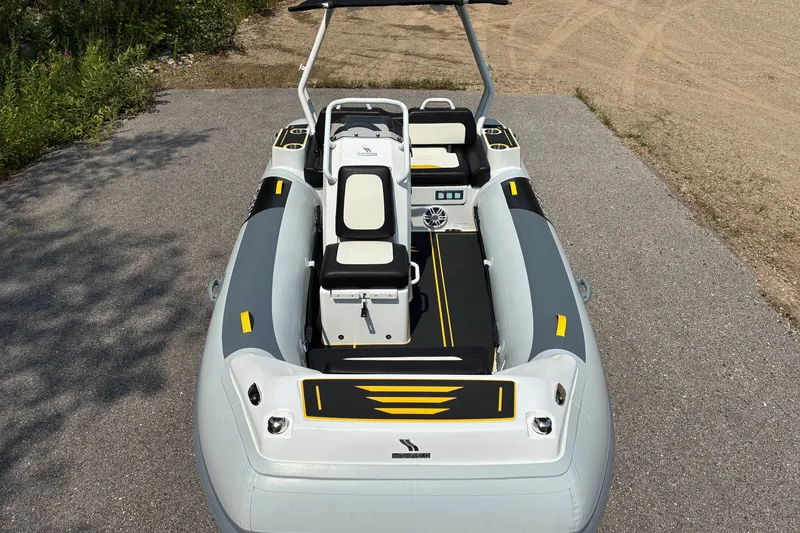 Slide: The Image of Highfield Velox 420 boat, 2026 model, featuring sleek design and modern seating on a paved surface. - 4