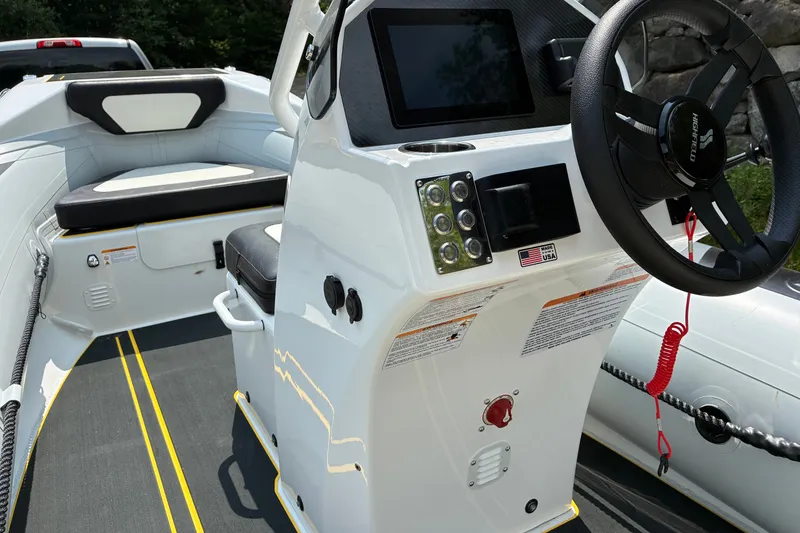 Slide: The Image of 2026 Highfield Velox 420 boat interior with steering wheel and control panel. - 12