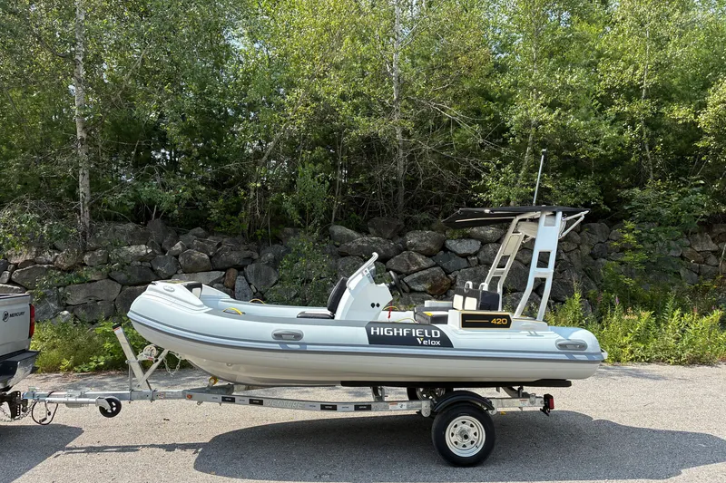 The Image of 2026 Highfield Velox 420 boat on trailer, parked near lush greenery. - 0