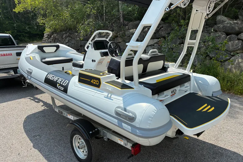 Slide: The Image of 2026 Highfield Velox 420 inflatable boat on trailer, parked outdoors. - 2