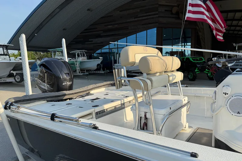 Slide: The Image of 2018 NauticStar 244 XTS boat with Yamaha 250 engine, docked near a modern building. - 17