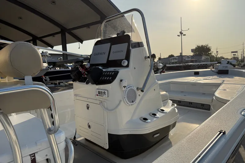 Slide: The Image of 2018 NauticStar 244 XTS boat with Garmin electronics, docked under a canopy. - 12