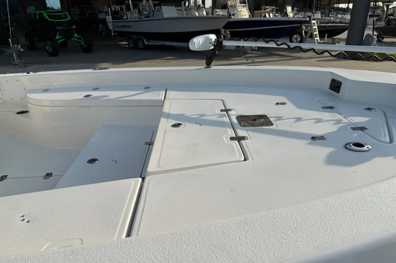 Slide: The Image of 2018 NauticStar 244 XTS boat deck with storage compartments and fishing rod holders. - 15