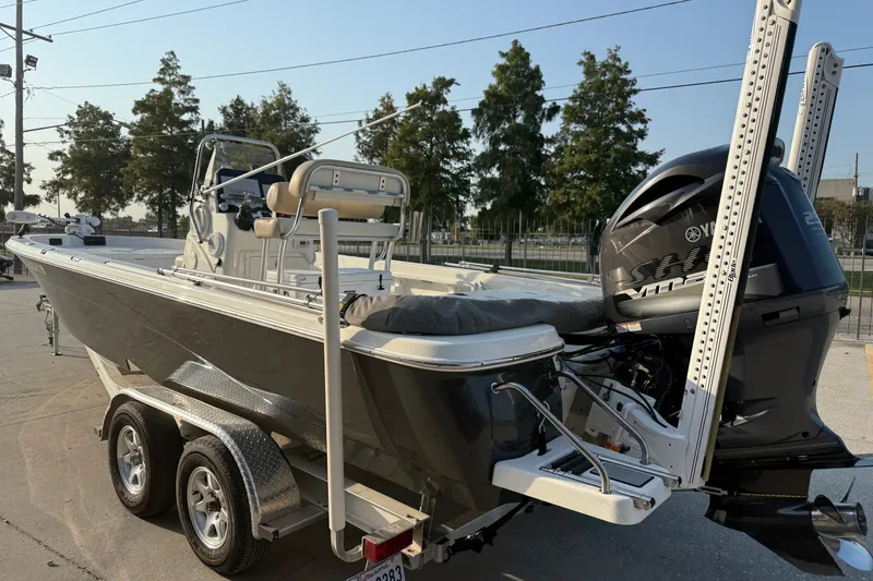 Slide: The Image of 2018 NauticStar 244 XTS boat on trailer with Yamaha outboard motor, parked outdoors. - 9
