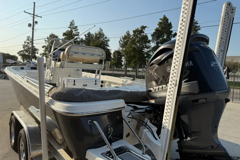 Slide: The Image of 2018 NauticStar 244 XTS boat with Yamaha engine on trailer, parked outdoors. - 10