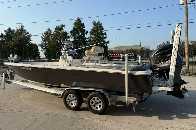 Slide: The Image of 2018 NauticStar 244 XTS boat on trailer with Yamaha engine, parked outdoors. - 8