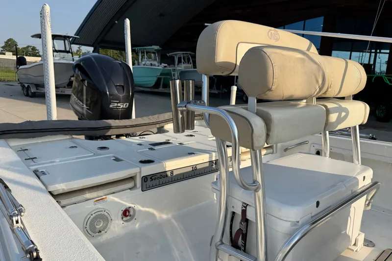 Slide: The Image of 2018 NauticStar 244 XTS boat with Yamaha 250 engine, featuring cushioned seating and fishing rod holders. - 13