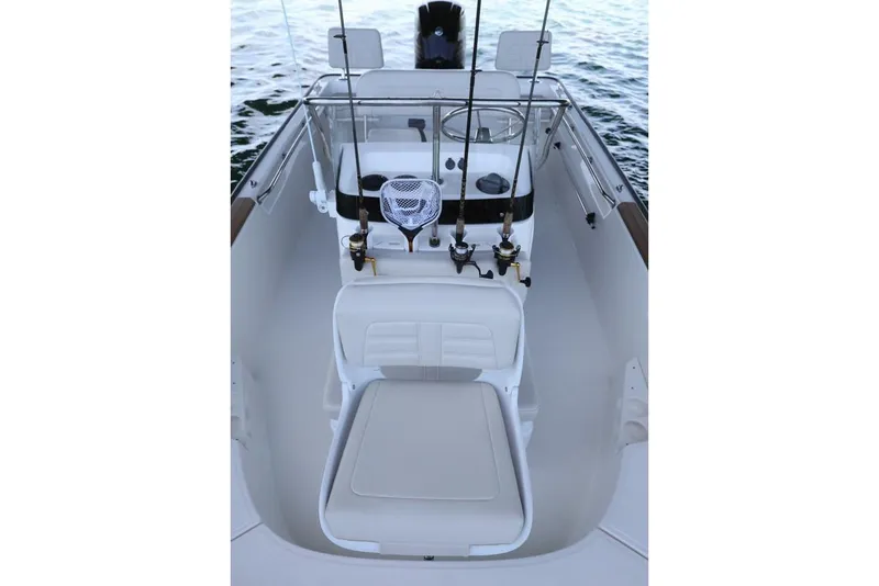 Slide: The Image of Manufacturer Provided Image: 2018 Boston Whaler 170 Montauk boat interior with fishing rods and seating. - 7