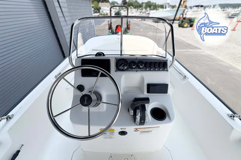 Slide: The Image of 2018 Boston Whaler 170 Montauk boat console with steering wheel and controls. - 5