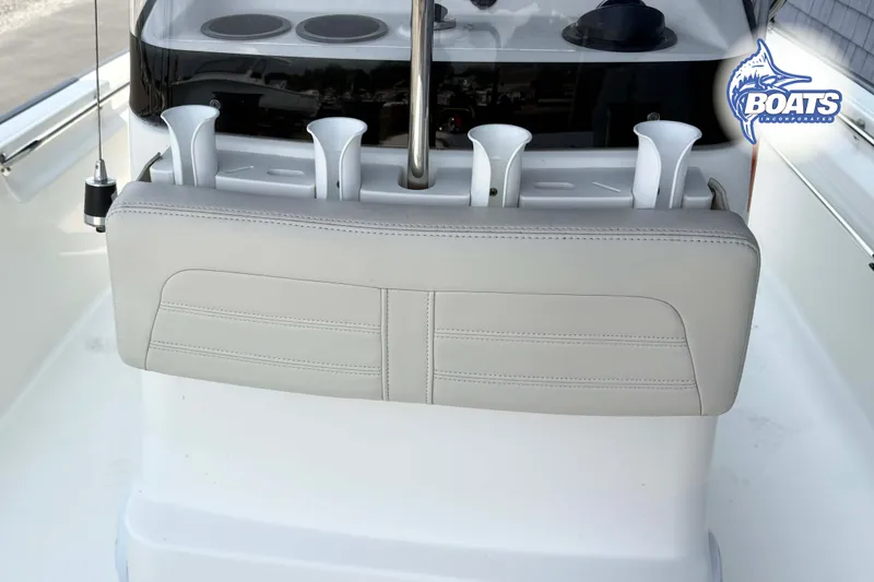 Slide: The Image of 2018 Boston Whaler 170 Montauk boat interior with rod holders and cushioned seating. - 8