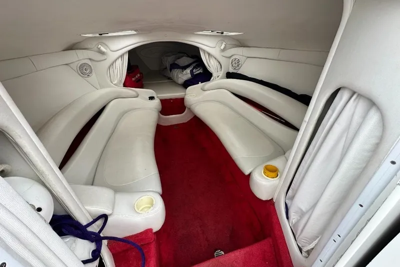 Slide: The Image of Interior of a 1999 Baja 29 Outlaw boat with white seating and red carpet. - 15