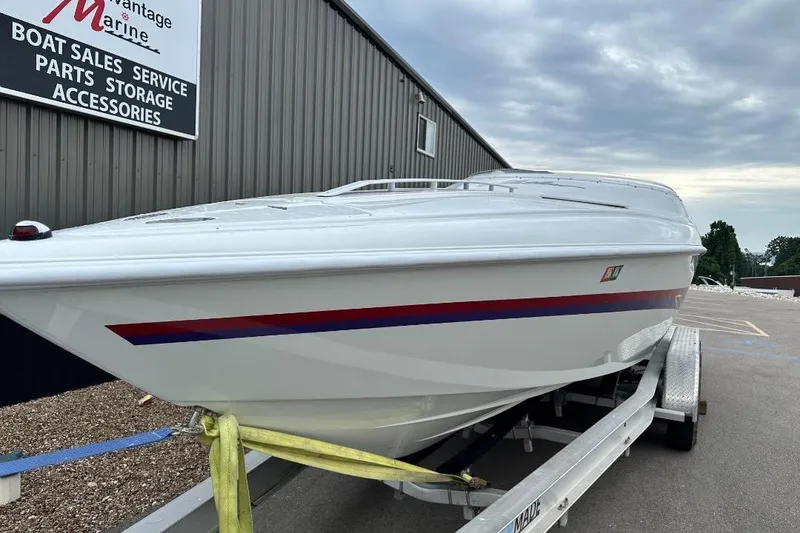 Slide: The Image of 1999 Baja 29 Outlaw boat on trailer at marine dealership. - 4