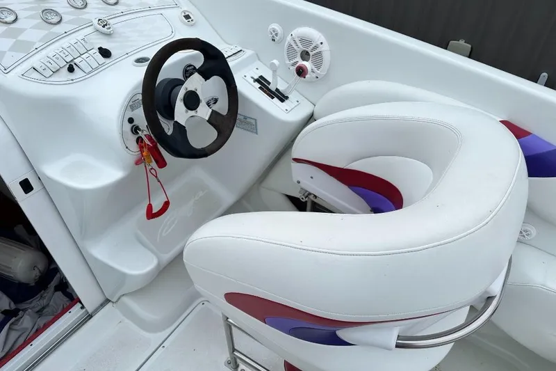 Slide: The Image of 1999 Baja 29 Outlaw boat cockpit with white and red seating, steering wheel, and dashboard controls. - 8