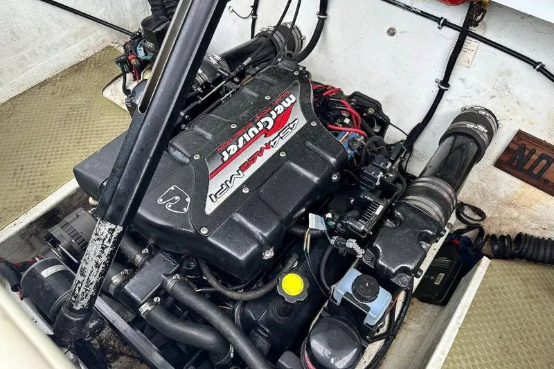 Slide: The Image of Engine compartment of a 1999 Baja 29 Outlaw boat with MerCruiser engine. - 13