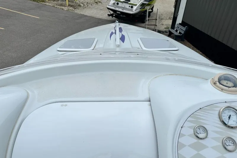 Slide: The Image of 1999 Baja 29 Outlaw boat deck with gauges and sleek design. - 10