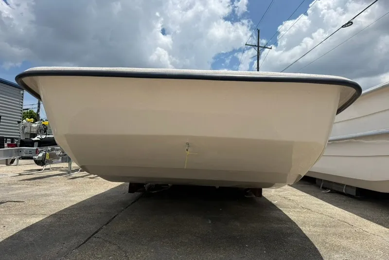 Slide: The Image of 2027 Carolina Skiff 2790 boat hull under a cloudy sky, parked on concrete. - 4