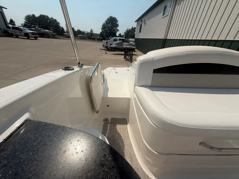 Slide: The Image of The image shows the cockpit of a 2011 Chaparral 244 Sunesta with white seating and a table. - 27