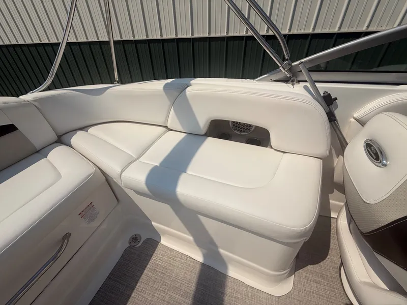 Slide: The Image of The image shows the white seating area of a 2011 Chaparral 244 Sunesta. - 25