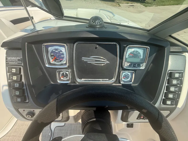 Slide: The Image of The image shows the dashboard of a 2011 Chaparral 244 Sunesta boat with various instruments. - 19