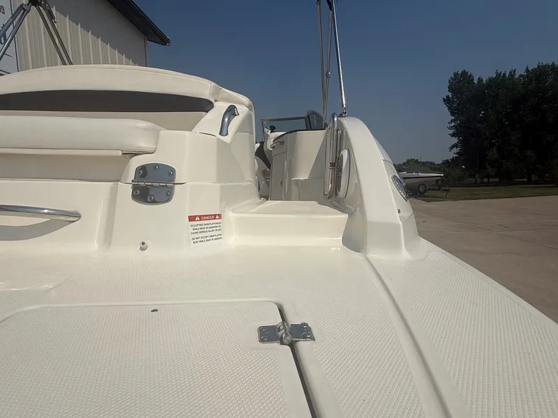 Slide: The Image of The image shows the stern of a 2011 Chaparral 244 Sunesta with a swim platform. - 11