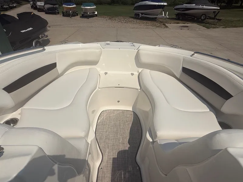 Slide: The Image of The image shows the cockpit of a 2011 Chaparral 244 Sunesta with white upholstery. - 13