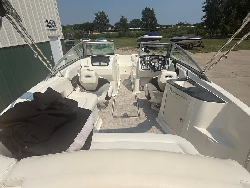 Slide: The Image of The image shows the cockpit of a 2011 Chaparral 244 Sunesta with white seating and a helm station. - 12
