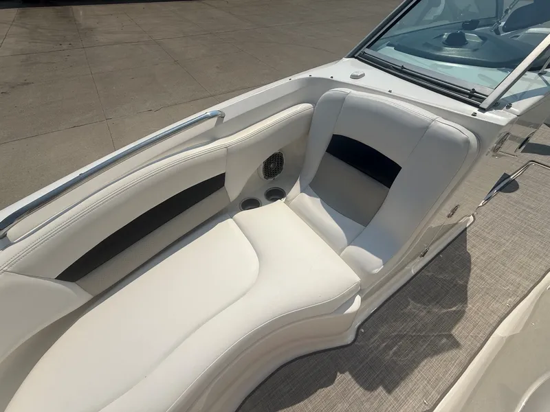 Slide: The Image of The image shows the seating area of a 2011 Chaparral 244 Sunesta boat with white upholstery. - 15