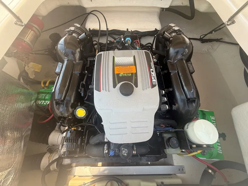 Slide: The Image of The engine compartment of a 2011 Chaparral 244 Sunesta shows a well-maintained engine. - 30