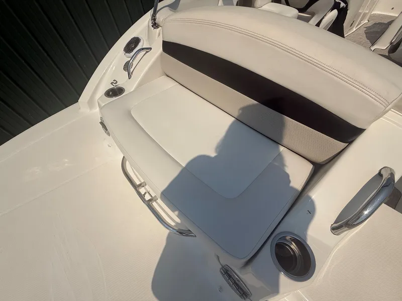 Slide: The Image of The image shows a white bench seat on a boat with stainless steel handles and cup holders. - 33