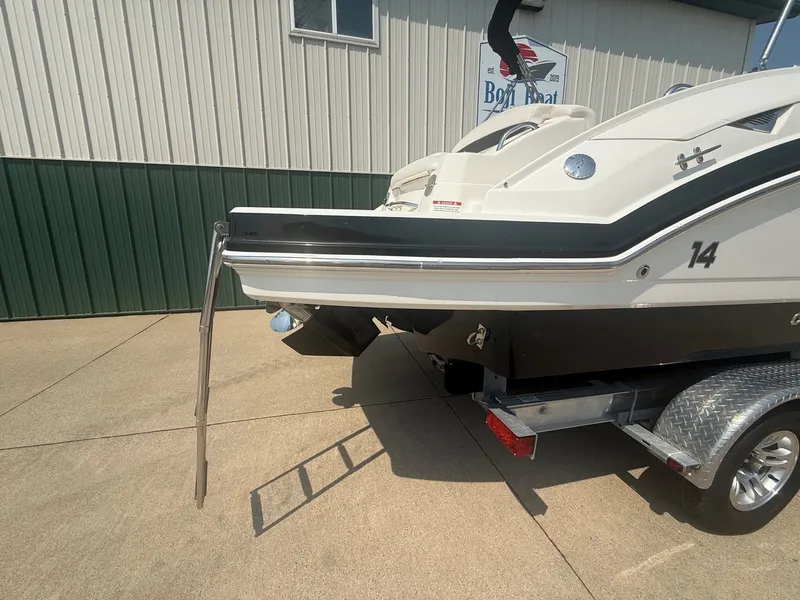 Slide: The Image of A 2011 Chaparral 244 Sunesta on a trailer, featuring a retractable swim ladder at the stern. - 9