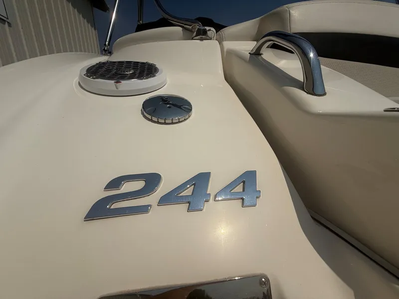 Slide: The Image of Close-up of the 2011 Chaparral 244 Sunesta with shiny emblem and sleek details. - 8