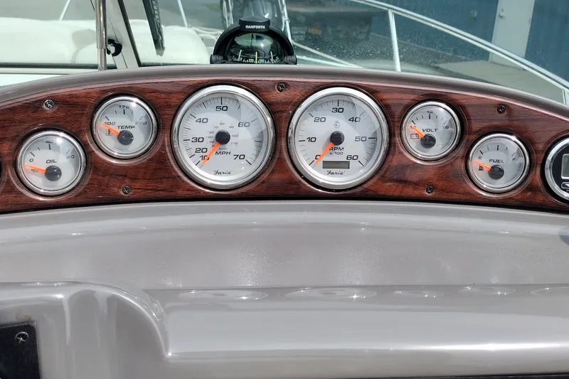 Slide: The Image of Dashboard of a 2006 Doral Monticello 250 boat with gauges for oil, temperature, speed, RPM, voltage, and fuel. - 42
