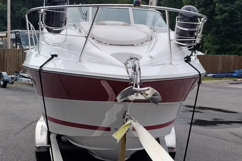 Slide: The Image of 2006 Doral Monticello 250 boat on trailer, front view, red and white design. - 3
