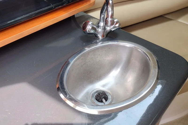 Slide: The Image of Stainless steel sink and faucet in 2006 Doral Monticello 250 boat interior. - 27
