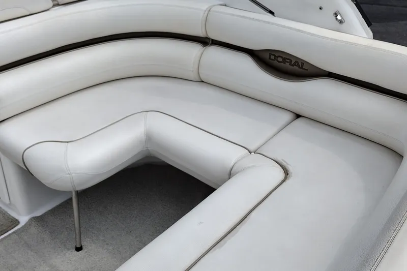 Slide: The Image of 2006 Doral Monticello 250 boat interior with white cushioned seating. - 13
