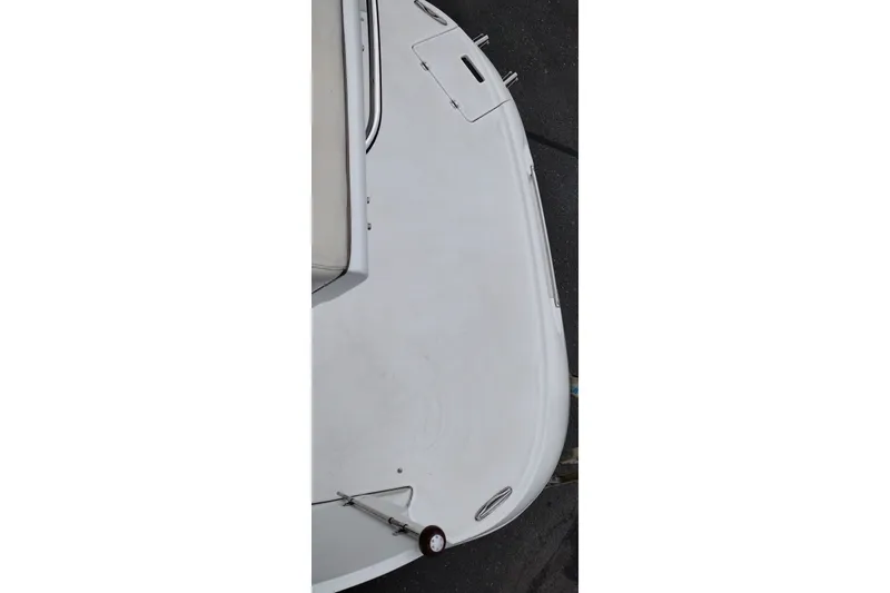 Slide: The Image of 2006 Doral Monticello 250 boat deck, featuring sleek white surface and stainless steel fittings. - 45