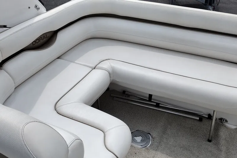 Slide: The Image of 2006 Doral Monticello 250 boat interior with white cushioned seating. - 16