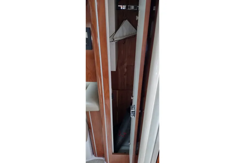 Slide: The Image of Interior closet of 2006 Doral Monticello 250 boat with wooden finish. - 29