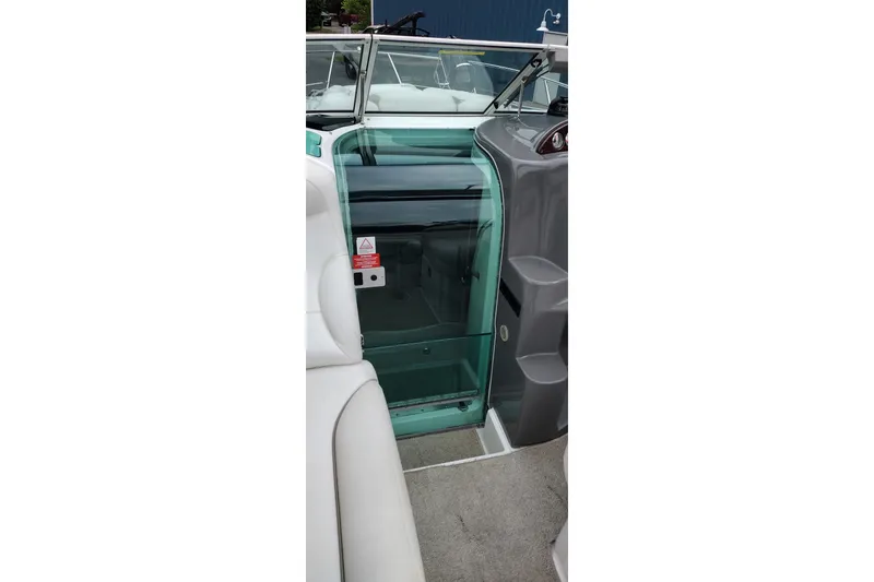 Slide: The Image of 2006 Doral Monticello 250 boat interior with glass door and seating area. - 44