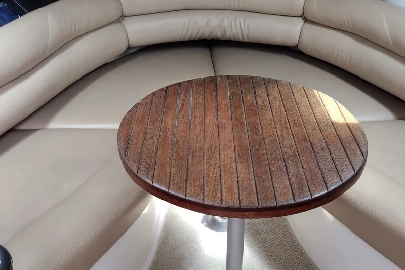 Slide: The Image of Interior of 2006 Doral Monticello 250 with wooden table and beige seating. - 21
