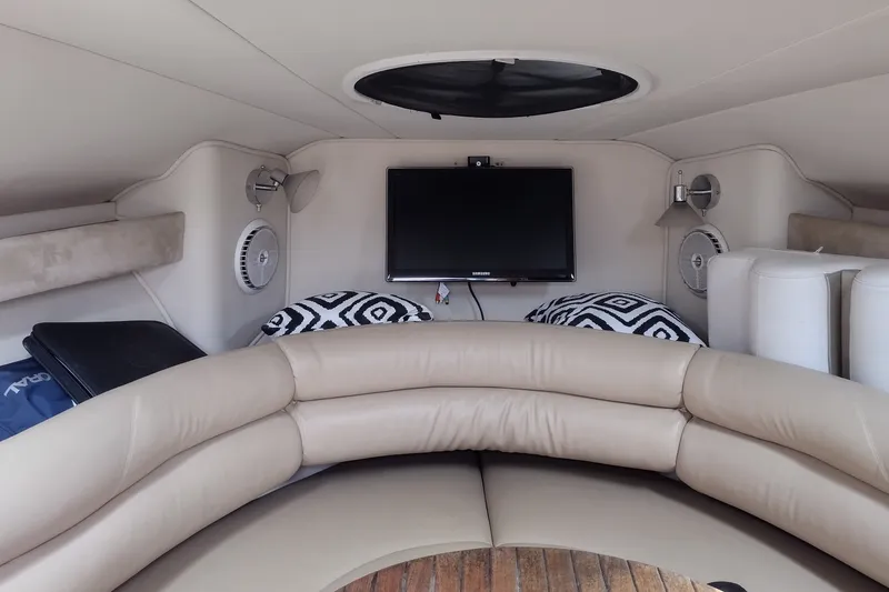 Slide: The Image of Interior of 2006 Doral Monticello 250 boat with beige seating and TV. - 20