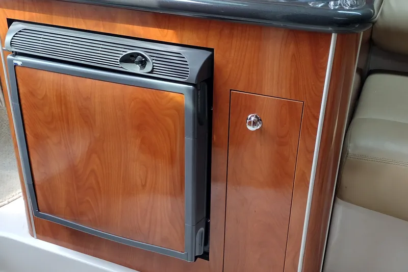 Slide: The Image of 2006 Doral Monticello 250 interior with wood finish and compact refrigerator. - 23